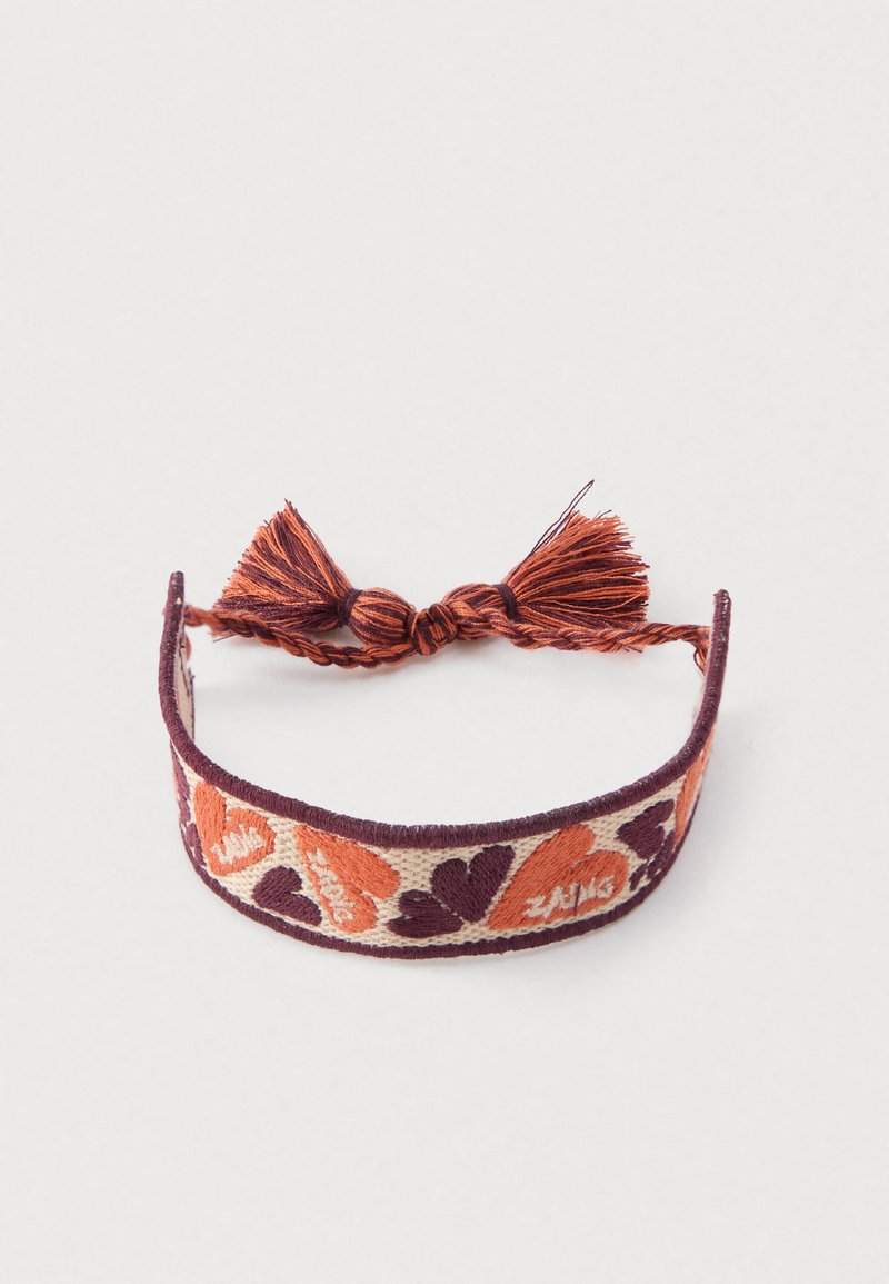 Woven fabric bracelet with hearts in orange and dark purple. Features a burgundy trim and decorative tassel for closure.
