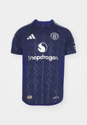 Navy blue football jersey with short sleeves, polo collar, textured design, and white logos: "Manchester United" and "Snapdragon."