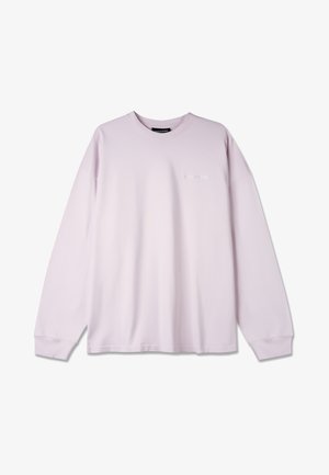 Light purple long-sleeve shirt made of soft cotton. Features a crew neck and subtle front logo with relaxed, loose-fitting design.