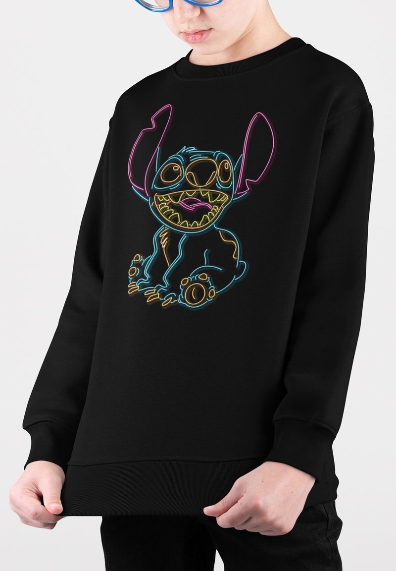 Felpa nera con grafica del personaggio Stitch a colori brillanti in blu neon, rosa e giallo. Tessuto morbido con polsini e fondo a costine.