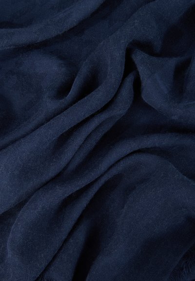 Tissu doux bleu foncé avec de légers plis et une texture tissée subtile visible sur toute la surface.
