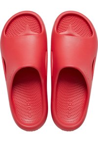 Chanclas de goma rojas con una superficie lisa, plantilla perforada y detalles recortados en los laterales. Nombre de la marca "crocs" grabado en una chancla.