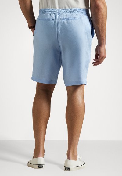 Light blue shorts with an elastic waistband, featuring two back pockets and a casual design. Material appears soft with a textured finish.