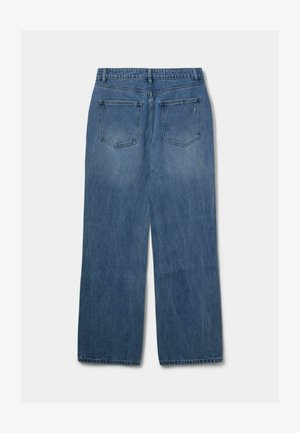 Sinine denimist valmistatud sirge säärega teksad, millel on kaks tagumist taskut ja veidi kulunud välimus. Tavaline vöökoht koos vöörihmadega.