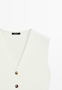 Witte mouwloze V-hals vest met twee bruine knopen en een zwart label binnen in de kraag met de tekst Massimo Dutti.