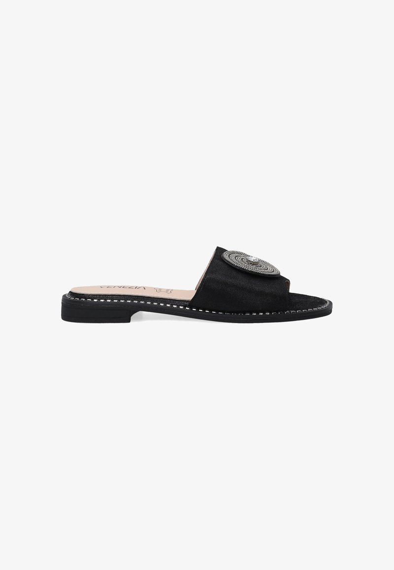 Black suede slide sandals with an open toe and a circular silver embellishment. Features a flat sole with contrasting stitching accents.