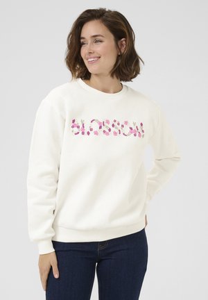Felpa girocollo di colore avorio con ricami floreali rosa sul petto. Presenta maniche lunghe e polsini a coste. Tessuto morbido.
