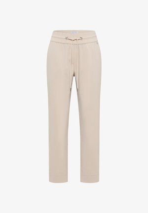 Pantalon beige à taille élastique avec cordon et œillets métalliques, jambes droites et petite étiquette logo sur le côté.