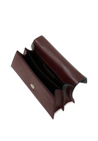 Burgundy leather wallet with three compartments, a snap closure, and smooth texture. Features contrasting light stitching along edges.