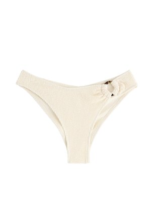 Cremefarvet bikiniunderdel med struktureret materiale, højt skårne sider og en knyttet detalje ved hoften.