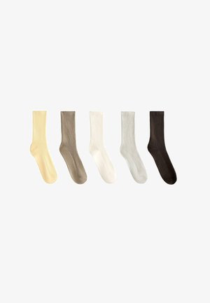 Five pairs of ribbed socks in light yellow, taupe, white, light gray, and dark brown. Each sock has a smooth texture and a consistent shape.