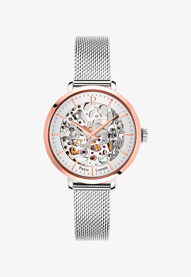 Zegarek szkieletowy ze srebrną bransoletą sieciową i różowym złotym pierścieniem. Posiada przezroczystą tarczę, która ukazuje skomplikowane mechanizmy i akcenty.