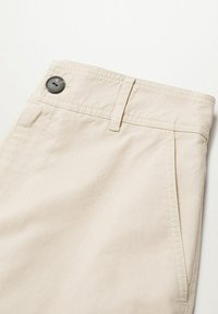 Beige trousers made of cotton, featuring a button closure, belt loops, and neatly stitched seams. Smooth texture with side pockets.
