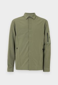 Olive green jacket with a buttoned collar, two zippered side pockets, and a zippered arm pocket. Smooth, lightweight fabric with a modern fit.