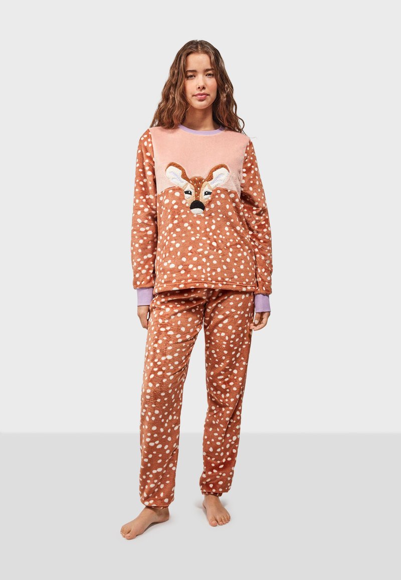 Fleece pajama set in brown with white polka dots. Top features a deer face design. Pants have an elastic waistband and matching pattern.