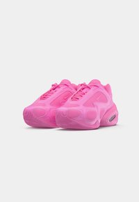 Bright pink athletic shoes with mesh panels, cushioned soles, visible air units, and lace-up design on a white background.
