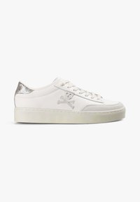 Zapatilla baja blanca con suela color marfil, cordones blancos, detalle en talón metálico plateado y bordado de calavera y tibias en el costado.