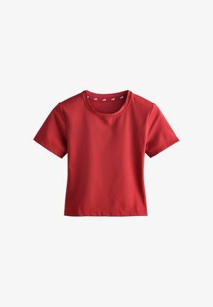 Red short-sleeve crew neck cropped top with smooth fabric and visible "self." branding inside the neckline.