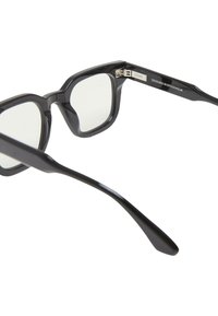 Occhiali da vista con montatura nera quadrata e lenti trasparenti, caratterizzati da una superficie liscia e tempie curvate. "DESIGNATO A STOCCOLMA" inciso sul braccio.