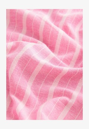Pink fabric features a textured surface with prominent white, vertical stripes. The material appears soft and lightweight, showing gentle draping.