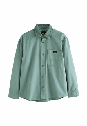 Dlouhý rukáv, košile v tlumené zelené barvě, vyrobená z bavlny. Obsahuje zapínání na knoflíky vpředu, náprsní kapsu a límec ze sametu. Jemný šev.