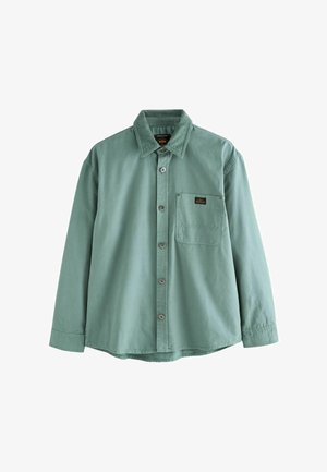 Garā piedurkņu krekls muted zaļā krāsā, izgatavots no kokvilnas. Iekļauj pogām aizdarāmu priekšu, krūšu kabatu un kordūras apkakli. Smalks šuvju details.