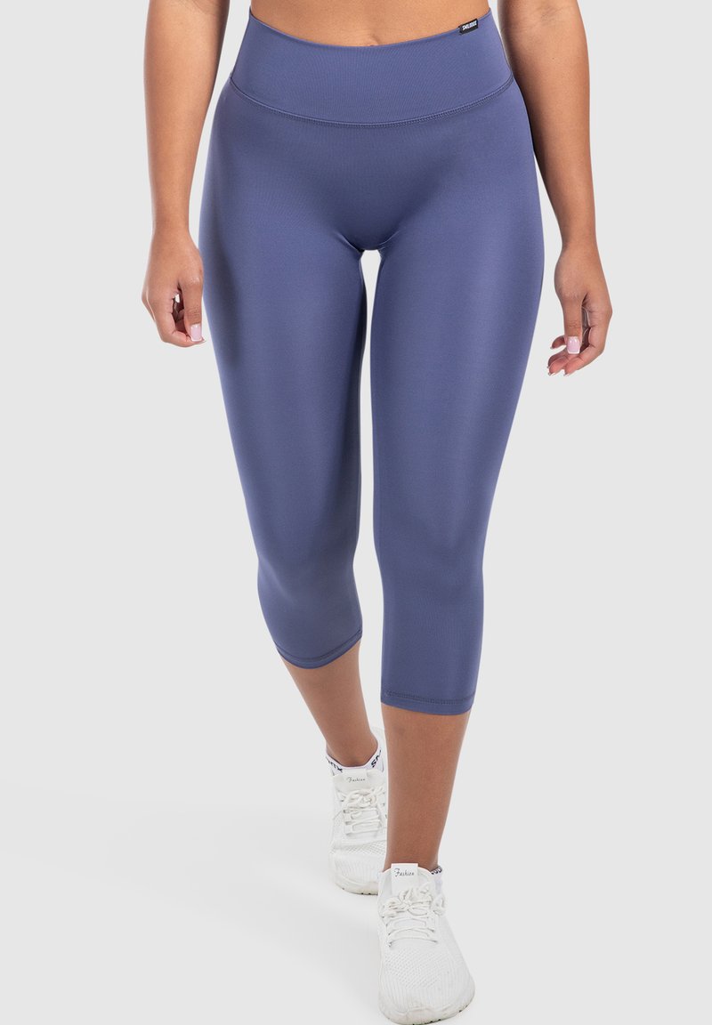 Leggings blu navy a vita alta realizzati in materiale elastico, progettati per comfort e mobilità, che arrivano poco sotto il ginocchio.