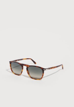 Tortoiseshell rectangular sunglasses with gradient dark lenses and thin arms angled on a white background.