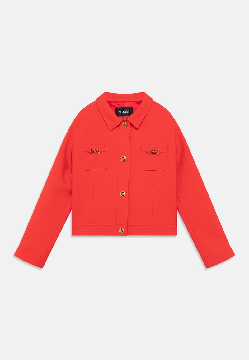 Veste rouge courte à manches longues, fermeture à bouton sur le devant, deux poches avant et quincaillerie dorée. Fabriquée en tissu uni et lisse.
