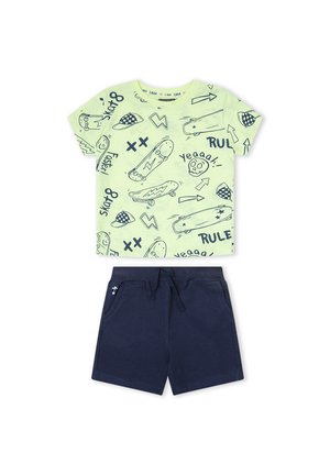 Camisa de manga corta verde claro con dibujos de monopatines y flechas en azul marino, combinada con pantalones cortos de cuerda lisos en azul marino para niños.