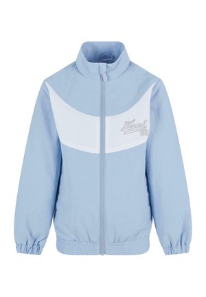 Light blue jacket with white panel across the chest, high collar, zip front, elastic cuffs, and embroidered logo detail on the left side.
