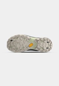 Vibram sole with a textured pattern; gray with green accents. Features lugs for traction and a curved design for stability.