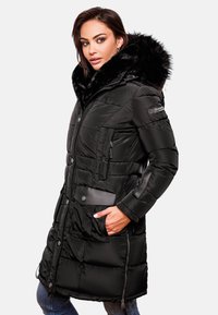 Black puffer coat with faux fur hood. Features quilted design, button and zip closures, and multiple pockets. Durable material with noticeable sheen.