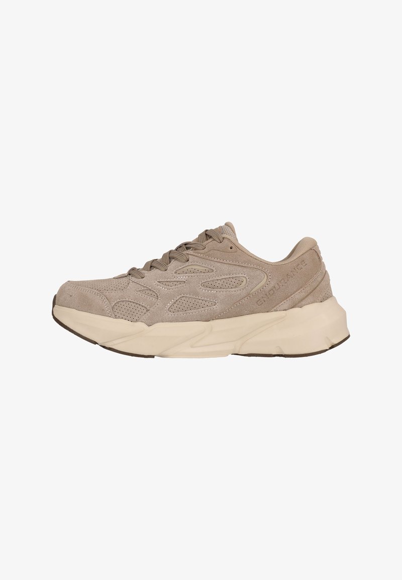 Beige athletic shoe with suede upper, textured accents, and perforations for breathability. Features a thick, cushioned sole and lace-up design.