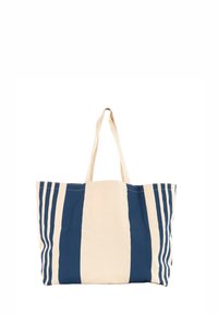 Tote bag in tela con strisce verticali blu e crema, dotata di due lunghe maniglie, ampio interno e texture resistente.