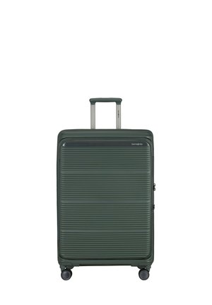 Green hard-shell suitcase with four wheels and a telescopic handle, featuring horizontal ridges and a front zipper pocket.