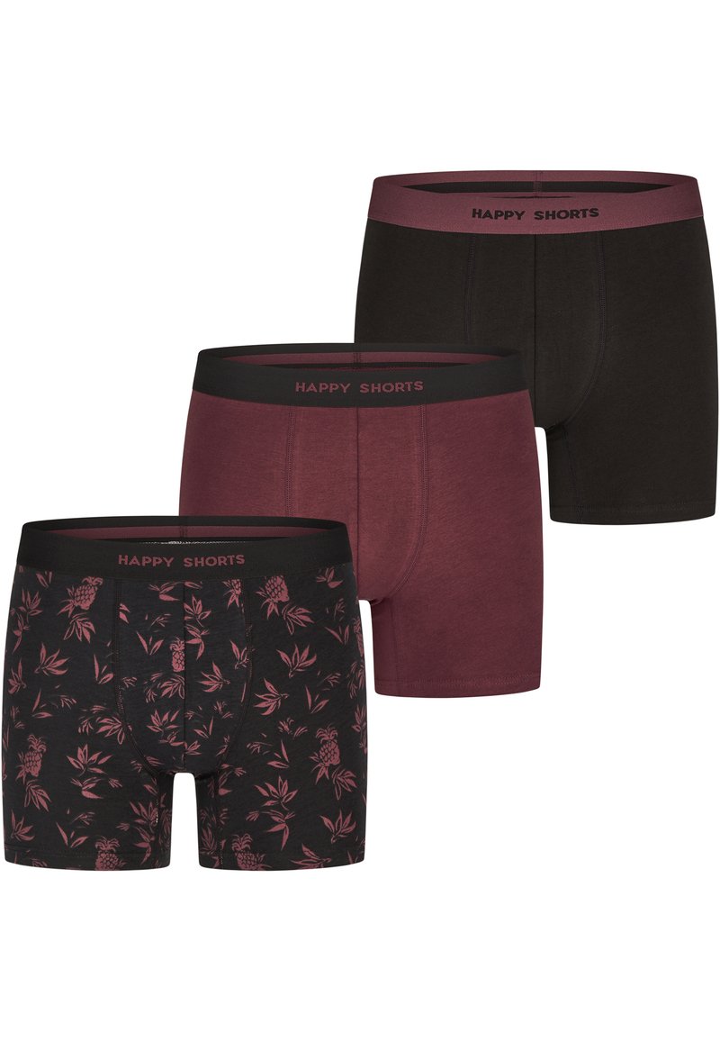 Tre paia di boxers in nero, bordeaux e un motivo floreale con ananas. Tessuto morbido con cinturini elastici etichettati "PANTALONCINI FELICI."