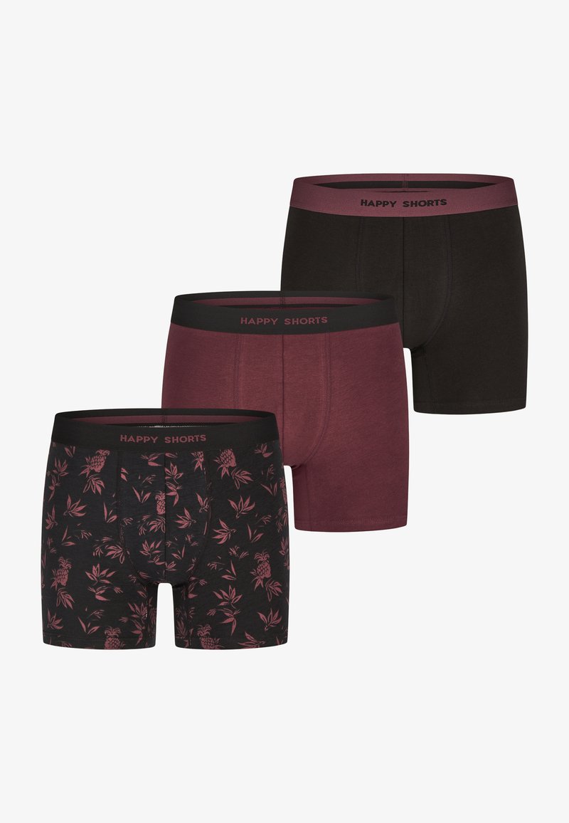 Tři páry boxerky v černé, burgundské a květinové vzoru s ananasy. Měkká tkanina s elastickými pasy označenými "ŠŤASTNÉ KRAŤASY."