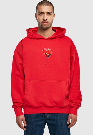 Red hoodie with a front pocket featuring a heart-shaped balloon graphic decorated with floral patterns. Soft fabric; relaxed fit.