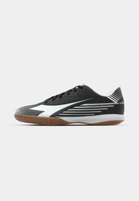 Black athletic shoe with a textured upper, white accents, and a gum rubber sole. Features diagonal line patterns and traditional lacing.