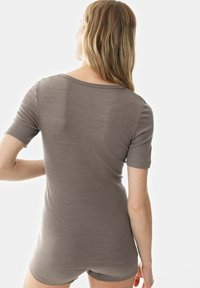Short-sleeve, ribbed top in a muted taupe color, featuring a wide neckline and a snug fit, paired with matching shorts.