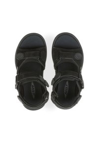 Sandalias negras con correas ajustables, plantillas acolchadas, parte superior texturizada y detalles de hardware en forma circular. Suela plana diseñada para la comodidad.