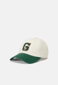 White baseball cap with green visor, featuring a "GAP" logo in dark green and orange. Made of fabric with a stitched design on the front.