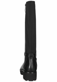 Black knee-high boots with a textured leather finish and a smooth fabric upper. Features a side zipper and a chunky rubber sole.