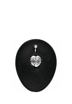 Black belly button with silver monstera leaf navel ring pierced at the top with a small jewel-studded silver barbell.