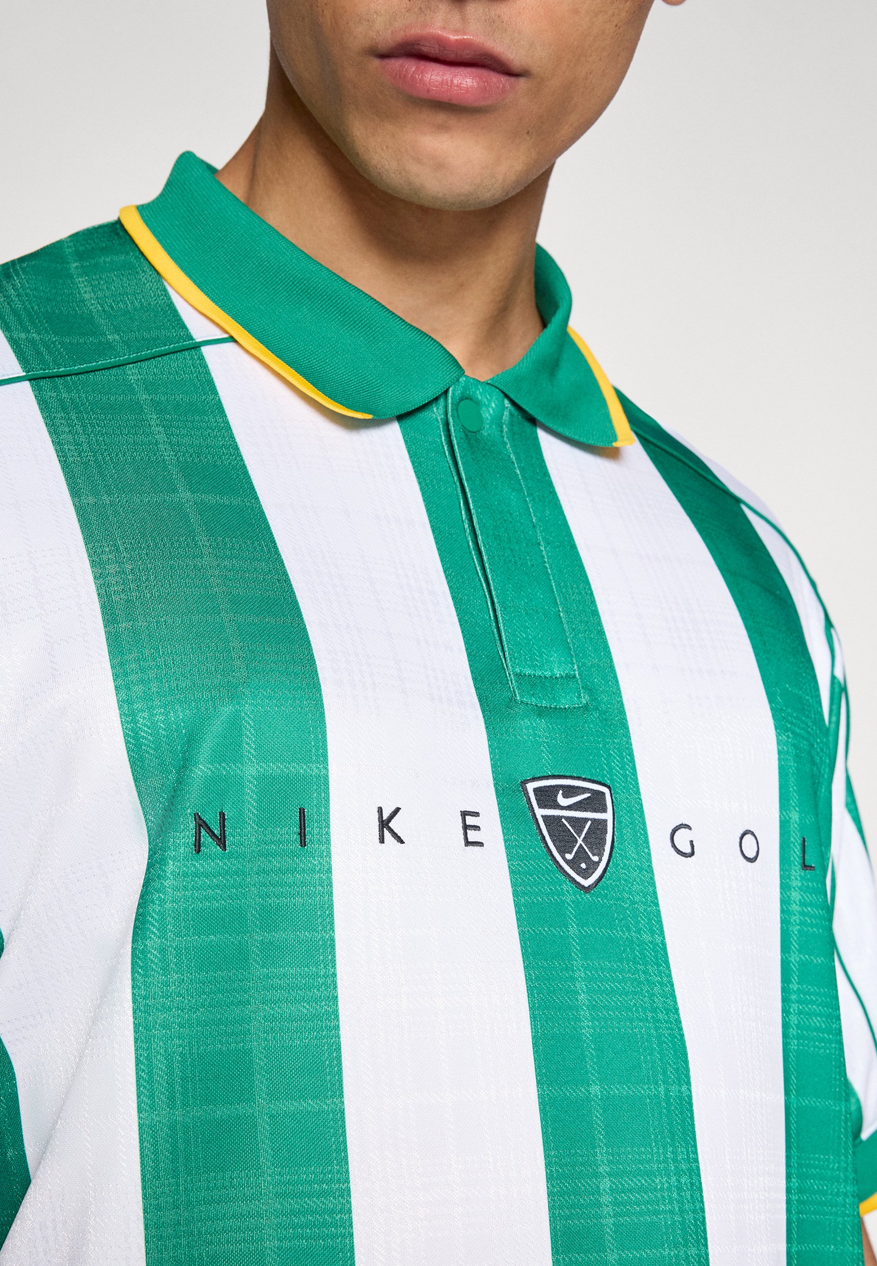 green and gold nike shirt
