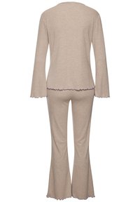 Svijetlosmeđi loungewear set koji se sastoji od dugih rukava i trapezastih hlača, izrađen od mekog materijala, s valovitim rubom i ljubičastim detaljima.