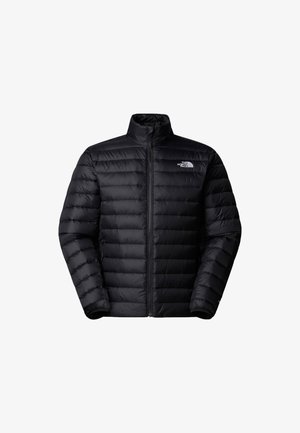 Zwarte pufferjack met een hoge kraag en ritssluiting. Heeft een gewatteerde textuur en elastische manchetten. Logo op het linkerborstgebied.