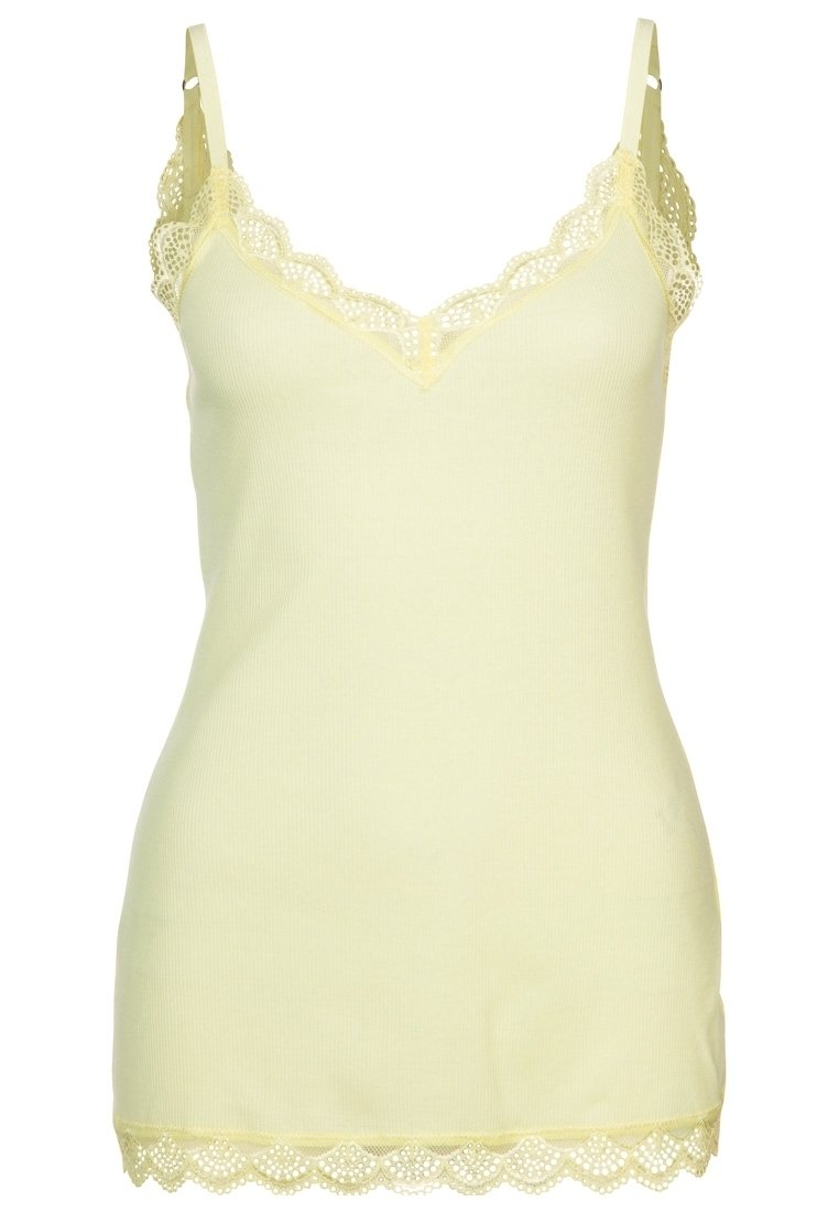 Ljust gul, ribbad linne med delikat spetskant längs halsringning och fåll. Utrustad med justerbara band och en figurnära design.
