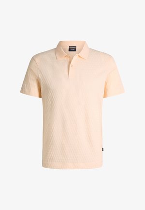 Polo pêche à manches courtes avec motif texturé, patte de boutonnage et col, étiquette de marque visible à l'intérieur du col.
